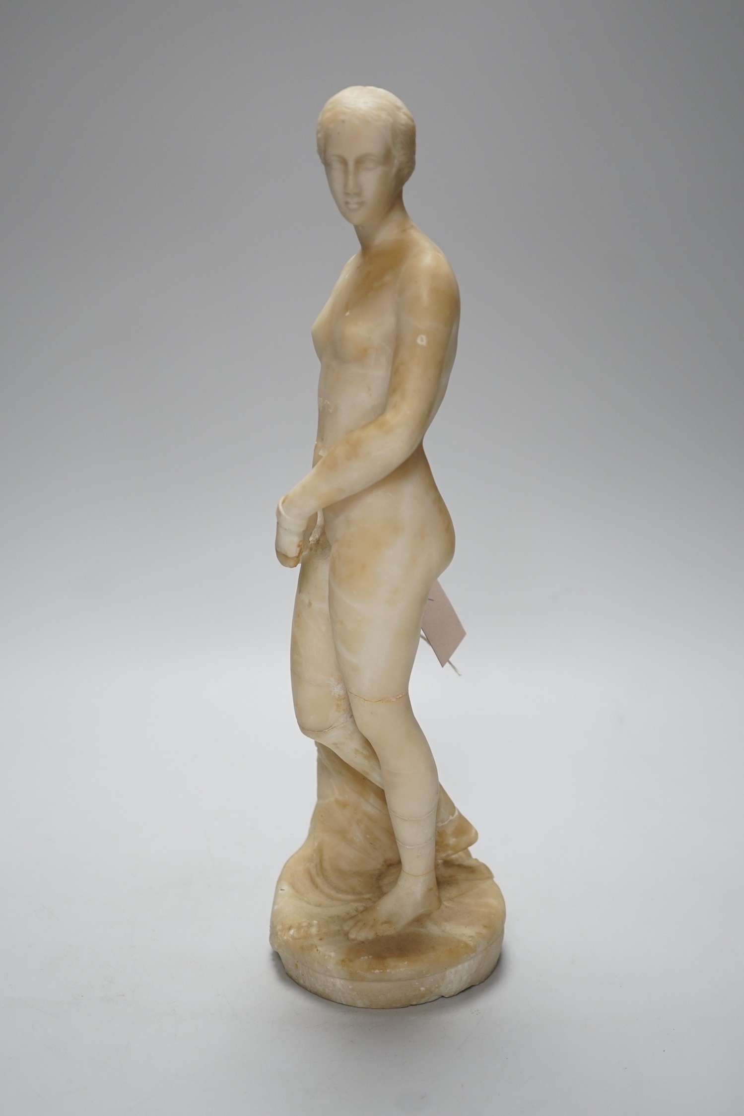 A carved alabaster female classical figure, the Greek slave Hiram Powers, 36cms high